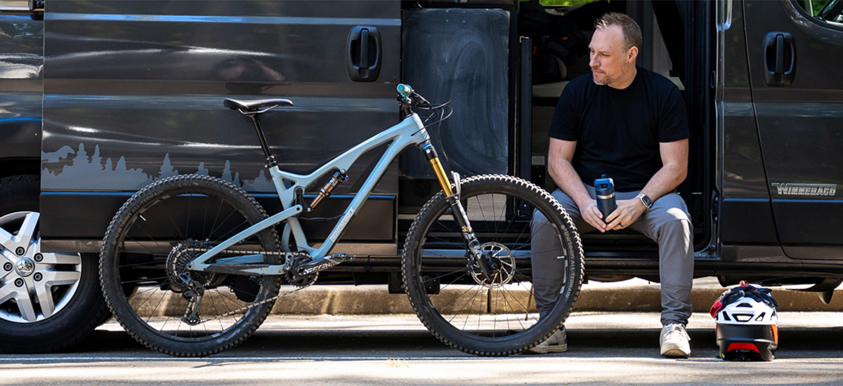 Guy sitting next to bike