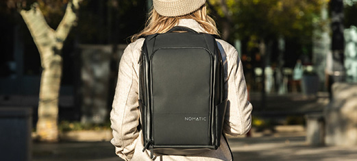 Person wearing Nomatic Bag in a Park