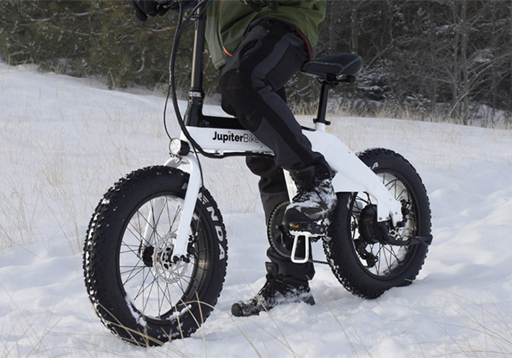 person on e-bike in the snow