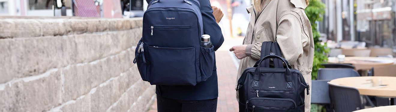 couple talking on the street holding bags